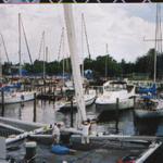 Crew in the process of stepping the mast.