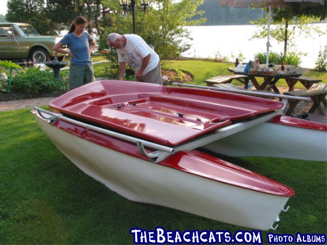 The hulls and deck are made of fibreglass. The mast is 20ft. and the length is about 13ft. Lots of sail for a small boat.