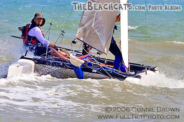 Pulling up dagger boards before hitting the beach.