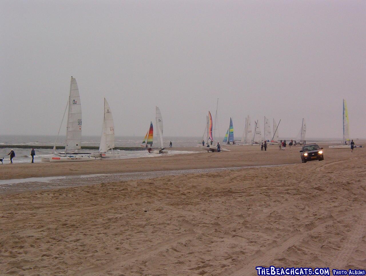 Sailors getting ready for some sailing in the rain.