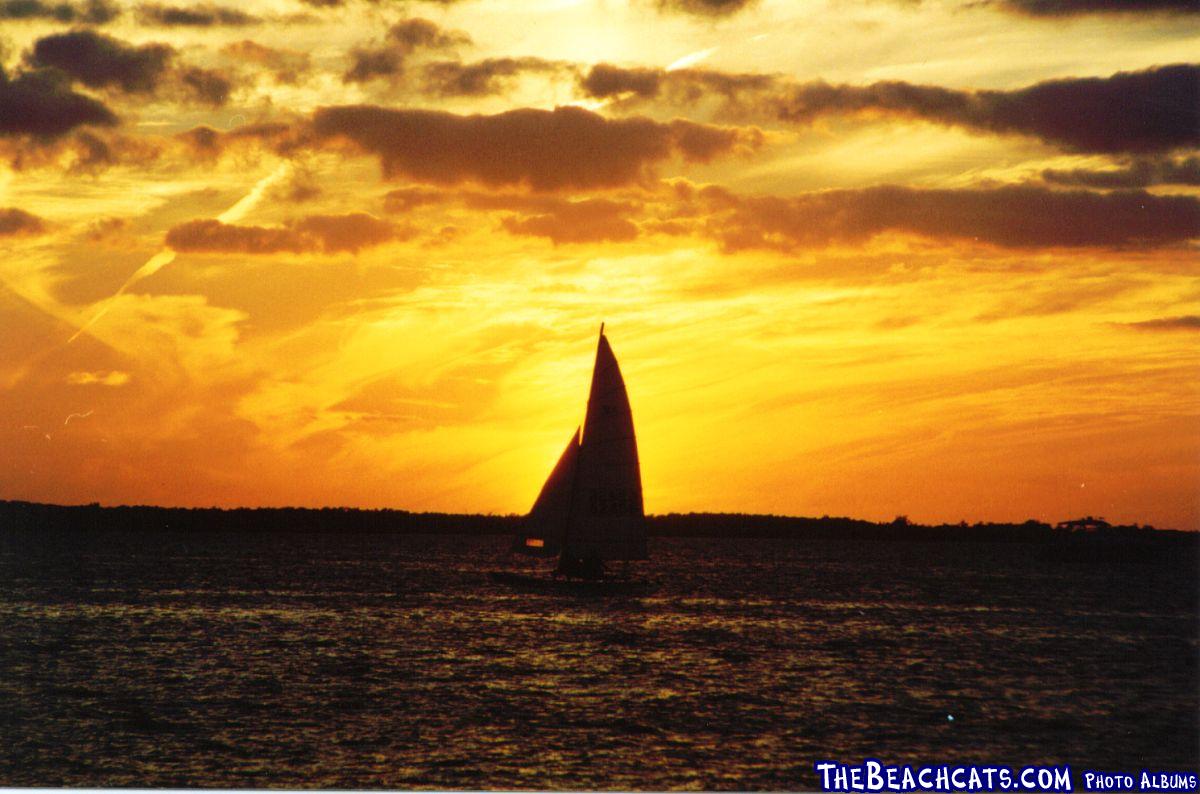 A Hobie 16 passing by during sunset