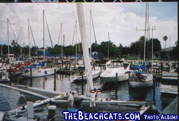 Crew in the process of stepping the mast.