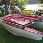 The hulls and deck are made of fibreglass. The mast is 20ft. and the length is about 13ft. Lots of sail for a small boat.