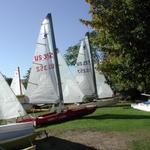 some of the boats at rest on a grassy beach.