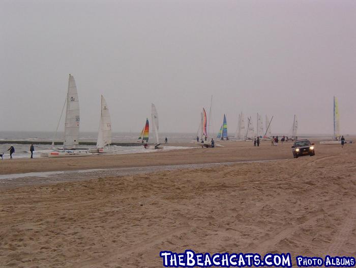 Sailors getting ready for some sailing in the rain.